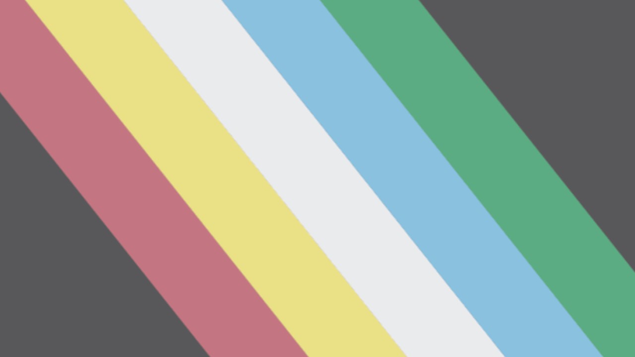 “Straight Diagonal” version of the Disability Pride Flag: A charcoal grey flag with a diagonal band from the top left to bottom right corner, made up of five parallel stripes in red, gold, pale grey, blue, and green.