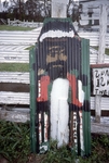 Man Painted on Corrugated Metal, Leaned Against Fence