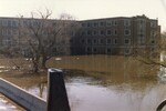 "Smith Hall (dormitory on UND campus) flooded; white spots in water are failed sandbag dike" by Jim Watt