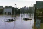 "University Ave. & North 4th Street looking at the City Hall parking lot, Lyons Auto & GF Herald" by Jim Watt