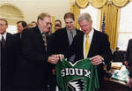 UND Men's Hockey Coach Dean Blais and Team Member Brad DeFauw with President Bill Clinton by United States. White House Photographic Office