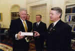 UND President Charles Kupchella and US President Bill Clinton Discuss a Box of Chippers by United States. White House Photographic Office